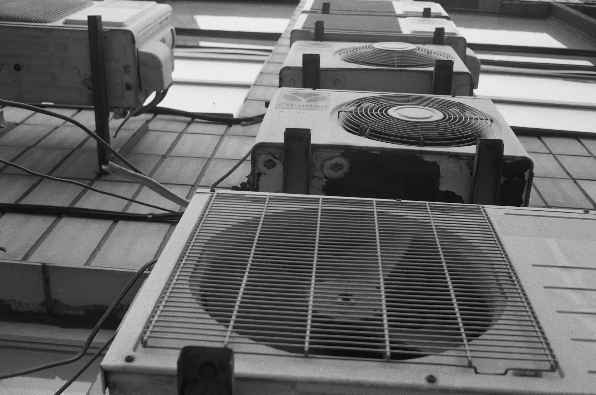 a series of AC units on a tiled floor
